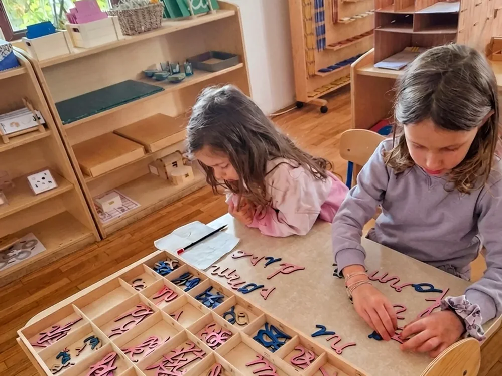 Copii lucrând cu alfabetul mobil într-o clasă Arcadia Montessori, Corbeanca